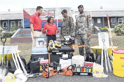  ??  ?? Tricia Jackson (second left), operations manager, Hi-Pro Farm Supplies Store, makes a point to Lieutenant Colonel Mahatma Williams (second right), commanding officer 1, Engineer Regiment, Jamaica Defence Force (JDF), while Regiment Sergeant Major...