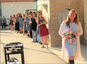  ?? Courtesy photo | Lee Morrell ?? (Above) Teachers wait in line at the start of a back-to-school event at James Foster Elementary School in the Saugus Union School District. (Below left) Parents also lined up to get into classrooms Tuesday. (Below right) New Principal Misty Covington greets parents at James Foster Elementary.