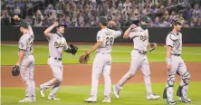  ?? Abbie Parr / Getty Images ?? The A’s celebrate their 32 win over the Mariners at TMobile Park in Seattle, which snapped a threegame losing streak.