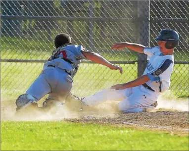  ?? PETE BANNAN — DIGITAL FIRST MEDIA ?? Lionville’s Austin Taylor is safe at home as Spring City catcher Ryan Harvey can’t make the tag in time Monday night.