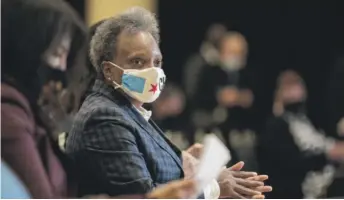  ?? PAT NABONG/SUN-TIMES PHOTOS ?? Mayor Lori Lightfoot applauds during the awarding of Invest South/West winners at the South Shore Cultural Center on Thursday. She called the projects “positive, catalytic” and “long-lasting.”