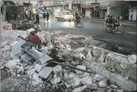  ?? (AFP) ?? A view of destructio­n along the side of a road in the aftermath of a car bomb explosion in the Turkish-controlled town of Al-Bab in Syria’s northern Aleppo governorat­e on Saturday.