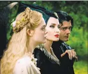  ??  ?? QUEEN AURORA (Fanning, left), Maleficent (Jolie) and Diaval (Riley) share a moment in the picture.