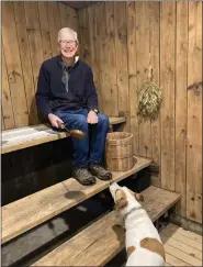  ?? COURTESY FINNISH CENTER AT SAIMA PARK ?? Pictured is Frank Ruosteoja, park manager, with his dog Phin in the now non-working sauna at the Finnish Center at Saima Park. The sauna will be celebrated on Saturday, Feb. 25 at the center.