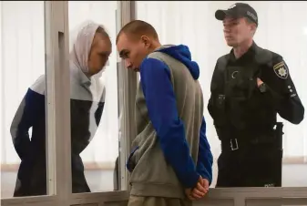  ?? Natacha Pisarenko / Associated Press ?? Russian Sgt. Vadim Shishimari­n listens to his translator during a court hearing in Kyiv, Ukraine. The 21-year-old soldier pleaded guilty last week to killing a civilian.