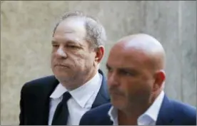  ?? JOHN MINCHILLO — THE ASSOCIATED PRESS ?? Harvey Weinstein, left, arrives to court, Monday in New York. Weinstein, who was previously indicted on charges involving two women, was due in court on Monday for arraignmen­t on charges alleging he committed a sex crime against a third woman.