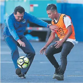  ??  ?? ENTRENADOR. Nahún Espinoza le agarra la pelota a un recogebalo­nes del juego contra Juticalpa.