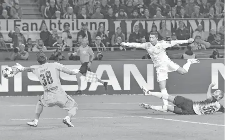  ?? AP Photo/Martin Meissner ?? GOAL! Real Madrid's Cristiano Ronaldo, center, scores his side's 3rd goal during the Champions League group H soccer match between Borussia Dortmund and Real Madrid CF in Dortmund, Germany, Tuesday, Sept. 26, 2017.