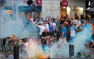  ??  ?? A teargas grenade explodes near an England fan ahead of England’s EURO 2016 match in Marseille. I could think of nothing worse than being in France for the tournament right now.