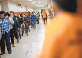  ?? David Goldman Associated Press ?? PEOPLE line up for a COVID-19 vaccine at a clinic last month in Central Falls, R.I., where nearly a third of adults in the city have received at least one dose.