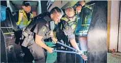  ?? Picture: AFP ?? York Regional Police cut the locks on gambling machines seized during raids in an illegal gaming investigat­ion named Project Sindacato in Vaughan, Ontario, Canada.