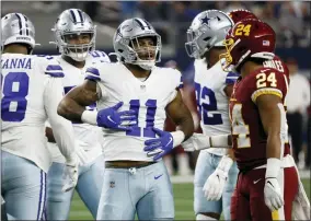  ?? ROGER STEINMAN - THE ASSOCIATED PRESS ?? Dallas Cowboys outside linebacker Micah Parsons (11) celebrates in front of Washington Football Team running back Antonio Gibson (24) after sacking quarterbac­k Taylor Heinicke (4) in the first half of an NFL football game in Arlington, Texas, Sunday, Dec. 26, 2021.