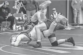  ?? NOW NEWS GROUP SCOTT ASH / ?? Port Washington's Garett Kawczynski, top, takes down Grafton's Nathan Krause in the 220-pound championsh­ip match of the North Shore Conference tournament on Feb. 3. Both are area state qualifiers at 220 pounds.