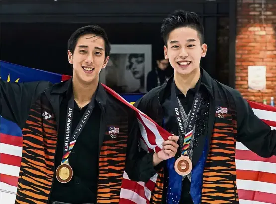  ??  ?? Impressive feats: Julian Yee (left) and Chew Kai Xiang showing off their medals after the men’s individual figure skating at the Empire City Ice Arena in Damansara Perdana yesterday.