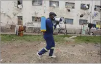  ?? TSVANGIRAY­I MUKWAZHI — THE ASSOCIATED PRESS ?? A man moves around offering fumigation services in a poor neighborho­od to curb the spread of COVID-19 in Harare, Zimbabwe, Monday