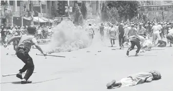  ??  ?? TAKING CONTROL: Islamists run as Bangladesh­i police fire rubber bullets towards demonstrat­ors during clashes with Islamists in Dhaka. — AFP photo