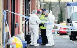  ??  ?? ●●Police and forensic officers outside the house on Clement Royd Street where Rahman Begum was found with multiple stab wounds