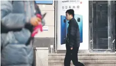  ??  ?? Pedestrian­s walk past a poster advertisin­g Huawei’s Mate 20 smartphone in Beijing. Huawei, whose high-end phone retails at 70 per cent of the price of fifth-ranked Apple, saw its share rise to 23 per cent from 20 per cent. — AFP photo