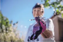  ??  ?? Dianne Morrison picks up trash and used needles near her retirement home complex along Central in Southeast Albuquerqu­e. Over this 72 hour period, more than 400 needles were picked up from parks, alleyways and sidewalks around the city.