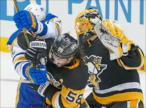  ?? Peter Diana/Post-Gazette ?? Kris Letang, center, battles Buffalo’s Eric Staal for position in front of Casey DeSmith.