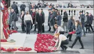  ??  ?? FLOWERS FOR FALLEN: Wreaths are laid on behalf of the public as they walk past the Cenotaph in the People’s Procession. PICTURES: PA.