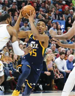  ?? (Reuters) ?? UTAH JAZZ guard Donovan Mitchell (45) controls the ball between two Cleveland Cavaliers defenders during the second half at Vivint Smart Home Arena as the Utah Jazz beat the Memphis Grizzlies 104-101 on Saturday night.