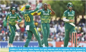 ??  ?? DAMBULLA: South Africa’s Kagiso Rabada (2nd right) celebrates with his teammates after he dismissed Sri Lankan cricketer Shehan Jayasuriya during the first One Day Internatio­nal (ODI) cricket match between Sri Lanka and South Africa yesterday. — AFP