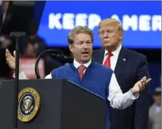  ?? Susan Walsh/Associated Press ?? President Donald Trump listens as Sen. Rand Paul, R-Ky., speaks during a campaign rally Monday in Lexington, Ky.
