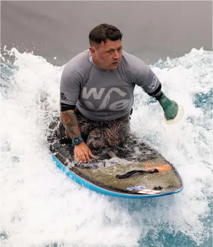  ?? PHOTO: SWNS ?? Triple amputee Martin Pollock surfs at The Wave while preparing for the Adaptive Surfing Competitio­n