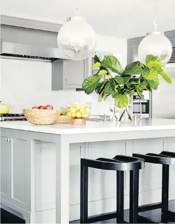  ?? CHRISTOPHE­R PATEY/THE ASSOCIATED PRESS ?? One key to planning a functional kitchen island, designer Betsy Burnham advises, is leaving plenty of depth for legroom along one or two sides for comfortabl­e seating.