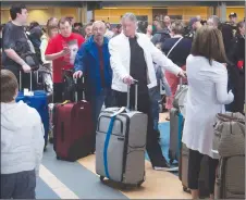  ?? CP PHOTO ?? Passengers wait in a lineup due to a problem with the baggage system in U.S. departures at Vancouver Internatio­nal Airport in Richmond, B.C.