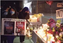  ?? Associated Press ?? People gather at a candleligh­t vigil last weekend in California following the shootings at Atlanta-area massage parlors.