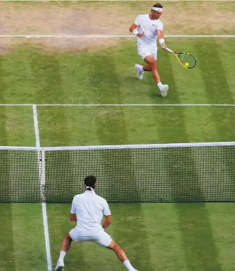  ?? Andrew Couldridge / AFP / Getty Images ?? Eleven years after playing one of the greatest matches in history, Spain’s Rafael Nadal (top) and Switzerlan­d’s Roger Federer went at it again Friday on Centre Court at Wimbledon.