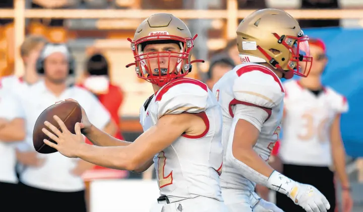  ?? ANDY LAVALLEY / POST-TRIBUNE PHOTOS ?? Andrean quarterbac­k Scott Ballentine looks to throw against Crown Point on Friday.