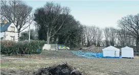  ??  ?? Police forensic tents at the site where the human remains were found