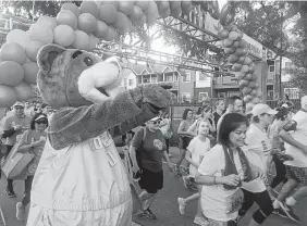  ?? Marialuisa Rincon / Staff ?? Rockets mascot Clutch cheers on more than 15,000 race participan­ts in the Komen Race for the Cure. This year, 11 Houston organizati­ons — including The Rose, MD Anderson Cancer Center and Baylor College of Medicine — are set to benefit from the more than $787,000 as of race day, not including day-of registrati­on or other donations.