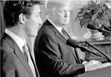  ??  ?? President Trump listens as Trudeau, Canada’s prime minister (left) speaks during a news conference at the White House in Washington, D.C. on Feb 13. — WP-Bloomberg photo