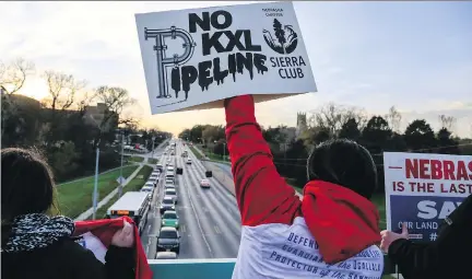  ?? NATI HARNIK/AP FILES ?? Opponents of the Keystone XL pipeline demonstrat­e in Omaha, Neb., on Nov. 1. The Nebraska regulators’ ruling to allow the pipeline to cross through the state was hailed by many business leaders, though TransCanad­a has yet to officially sanction the...