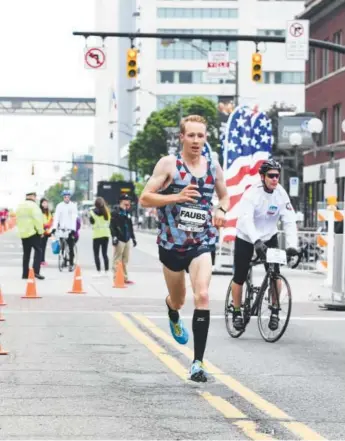  ??  ?? Scott Fauble, a former Wheat Ridge High School star who turned pro last year, finishes second at the U.S. Half Marathon Championsh­ips last month in Columbus, Ohio. Courtesy of Capital City Half Marathon