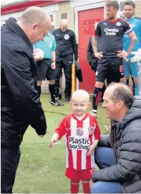  ??  ?? Charlie Procter meets Accrington Stanley chairman, Andy Holt, before leading out the Reds out before their SkyBet League 2 game with Crawley Town