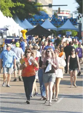  ?? STAFF PHOTO BY ERIN O. SMITH ?? Crowds enter the first night of this year’s Riverbend Festival on May 29. The number of attendees was noticeably smaller than previous years.