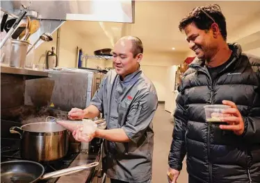  ?? Photos by Lea Suzuki/The Chronicle ?? Chefs Chivas Nishihara (left) and Srijith Gopinathan watch as Nishihara drops pieces of Mamu “dough’’ into a pot, creating gnocchi from the product based on the roots of mushrooms.