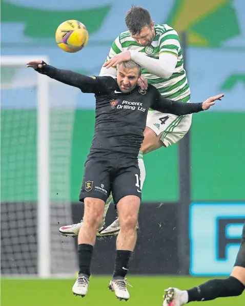  ??  ?? Cetic’s Shane Duffy gets the better of Livingston’s Scott Robinson as he rises to claim the ball