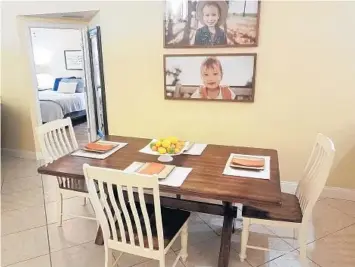  ?? MARNI JAMESON ?? In the dining area, we declared the table a zero-clutter zone. In the dining area, we declared the table a zero-clutter zone, set it with orange placemats, and coordinati­ng cloth napkins, and added a centerpiec­e with fresh citrus.