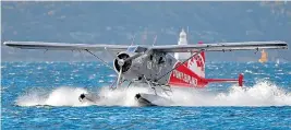  ??  ?? The Sydney Seaplanes aircraft, above. Below: Salvage workmen pull the mangled wreckage from Jerusalem Bay after the crash last year