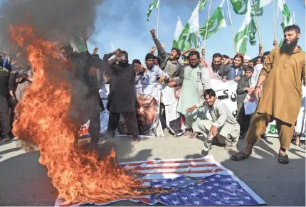  ??  ?? Difa-e-Pakistan Council activists shout anti-U.S. slogans in Karachi. President Trump has lashed out at Islamabad, saying the U.S. would suspend millions of dollars in security assistance to Pakistan. AFP/GETTY IMAGES