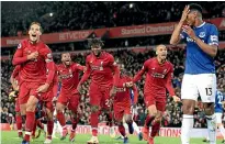  ?? AP ?? Liverpool players celebrate the match-winner against Everton.