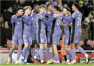  ?? /Reuters ?? Nail in Arsenal coffin: Liverpool’s Luis Diaz, left, celebrates scoring their second goal with teammates.