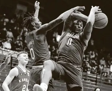  ?? Nick Krug / via Kansas Athletics ?? Kansas guard Marcus Garrett (0) pops the ball away from Baylor guard Mark Vital (11) during the second half at Allen Fieldhouse. The 17th-ranked Jayhawks hankded the second-ranked Bears their first loss.