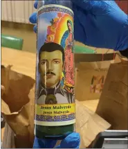  ?? BUCKS COUNTY DISTRICT ATTORNEY’S OFFICE ?? Along with drugs, cash, cell phones and a handgun, four Jesus Malverde candles were seized in connection with the drug case, Jesus Malverde is known as the patron saint of drug trafficker­s, Bucks County District Attorney Matt Weintraub said.